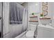 Well-lit bathroom featuring a shower, toilet, vanity, and decorative wall art at 9090 Josepine St, Pahrump, NV 89048