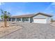 Stunning single-story home featuring an oversized driveway and manicured desert landscaping at 9090 Josepine St, Pahrump, NV 89048