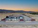 A serene view of a single-story desert home showcasing the expansive landscape and mountain backdrop at 9090 Josepine St, Pahrump, NV 89048