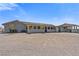 Single-story home with gravel yard and covered structure on a sunny day at 9090 Josepine St, Pahrump, NV 89048