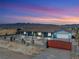 Single-story home with desert landscaping and a two-car garage, highlighted by a picturesque mountain view at sunset at 9090 Josepine St, Pahrump, NV 89048