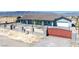 Charming single-story home with a red gate, desert landscaping, and mountain views at 9090 Josepine St, Pahrump, NV 89048