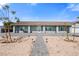 Single-story home featuring desert landscaping, a walkway, and custom exterior lighting at 9090 Josepine St, Pahrump, NV 89048