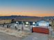 Charming single-story home with a red gate, desert landscaping, and mountain views at 9090 Josepine St, Pahrump, NV 89048