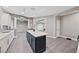 Spacious kitchen offers stainless appliances, a large center island with white countertop and gray cabinets at 9090 Josepine St, Pahrump, NV 89048