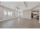 Bright, open living area with large windows, a ceiling fan, and seamless flow into the kitchen at 9090 Josepine St, Pahrump, NV 89048