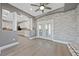 Open living space with tile accent wall, white trim and view of the open concept kitchen at 9090 Josepine St, Pahrump, NV 89048
