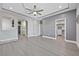 This main bedroom features tray ceilings and gray wood floors, with an ensuite bathroom and walk-in closet at 9090 Josepine St, Pahrump, NV 89048