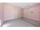 A small, pink room with gray floors and a caged area at 9090 Josepine St, Pahrump, NV 89048