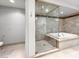 Beautiful bathroom featuring a glass shower, separate tub, and beige tile at 9101 Alta Dr # 18, Las Vegas, NV 89145