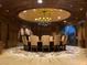 Elegant dining room featuring a unique chandelier, decorative ceiling mural, and custom flooring at 9101 Alta Dr # 18, Las Vegas, NV 89145