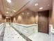 Neutral colored hallway with marble floors and paneled walls at 9101 Alta Dr # 18, Las Vegas, NV 89145