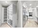 Pantry and kitchen with stainless steel appliances and white cabinets at 9101 Alta Dr # 18, Las Vegas, NV 89145