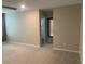 Neutral-toned bedroom with plush carpet and doorway, offering a serene and inviting atmosphere at 9343 Sully Ave, Las Vegas, NV 89149