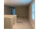A carpeted hallway is shown with natural paint and trim and a window with blinds at 9343 Sully Ave, Las Vegas, NV 89149