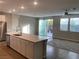 Modern kitchen featuring stainless steel appliances, open access to the living room and backyard access at 9343 Sully Ave, Las Vegas, NV 89149