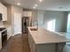 Open concept kitchen with stainless steel appliances, a large island and backyard access at 9343 Sully Ave, Las Vegas, NV 89149