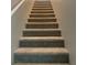 Carpeted staircase featuring neutral tones, providing safe access to upper levels of the home at 9343 Sully Ave, Las Vegas, NV 89149