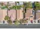 Aerial view of neighborhood homes, featuring desert landscaping, tile roofs, and multiple vehicles parked on the street at 9446 Baltinglass St, Las Vegas, NV 89123