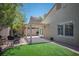 Cozy backyard with a pergola, artificial grass, and outdoor seating at 9446 Baltinglass St, Las Vegas, NV 89123