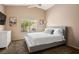 Neutral bedroom has a vaulted ceiling, large window, and dresser at 9446 Baltinglass St, Las Vegas, NV 89123