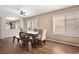 Spacious dining room with a modern table, bench, and hardwood floors at 9446 Baltinglass St, Las Vegas, NV 89123