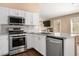 Modern kitchen featuring stainless steel appliances, granite countertops, and white cabinets at 9446 Baltinglass St, Las Vegas, NV 89123