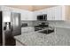 Stylish kitchen featuring stainless steel appliances, granite countertops, and ample cabinet space at 9446 Baltinglass St, Las Vegas, NV 89123