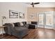 Cozy living room with hardwood floors, a comfortable sectional, and natural light at 9446 Baltinglass St, Las Vegas, NV 89123