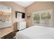Main bedroom has a television, large window, and bathroom access at 9446 Baltinglass St, Las Vegas, NV 89123