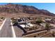 Aerial daytime view of home with solar panels, a pool, and mountain views at 979 Evening Dew Dr, Las Vegas, NV 89110