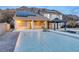 Large backyard with a pool, spa, and covered patio area against a mountain backdrop at 979 Evening Dew Dr, Las Vegas, NV 89110