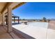 Backyard featuring a covered patio, swimming pool, desert landscaping, and mountain views at 979 Evening Dew Dr, Las Vegas, NV 89110