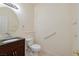 Cozy powder room includes a vanity, toilet, and accessible grab bars at 979 Evening Dew Dr, Las Vegas, NV 89110