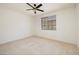 Bedroom with neutral carpet and baseboards featuring a ceiling fan and good lighting from window at 979 Evening Dew Dr, Las Vegas, NV 89110