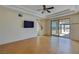 Spacious bedroom with gleaming hardwood floors, ceiling fan, and sliding doors to balcony at 979 Evening Dew Dr, Las Vegas, NV 89110