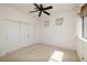 Bedroom featuring a ceiling fan, large closet, neutral carpet and baseboards, and well-lit window at 979 Evening Dew Dr, Las Vegas, NV 89110