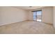 Large bedroom with sliding glass doors leading to the outdoor balcony at 979 Evening Dew Dr, Las Vegas, NV 89110