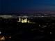Stunning night view with a Mormon church in the foreground and distant city lights at 979 Evening Dew Dr, Las Vegas, NV 89110