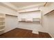 Walk-in closet with custom shelving and wood floor provides ample storage space at 979 Evening Dew Dr, Las Vegas, NV 89110
