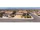 Aerial view of this beautiful home featuring a three-car garage, landscaping, and desert surroundings at 979 Evening Dew Dr, Las Vegas, NV 89110