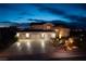 Exterior elevation of a home featuring a three-car garage, desert landscaping, and neighborhood surroundings at 979 Evening Dew Dr, Las Vegas, NV 89110