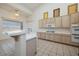 Bright kitchen with a large breakfast bar, tile countertops, and natural light at 979 Evening Dew Dr, Las Vegas, NV 89110