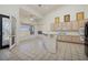 Bright kitchen featuring ample cabinetry, a breakfast bar, and stainless steel appliances at 979 Evening Dew Dr, Las Vegas, NV 89110