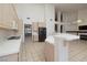 Open kitchen with a breakfast bar, tile countertops, and modern appliances at 979 Evening Dew Dr, Las Vegas, NV 89110