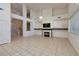 Bright living room with fireplace, large windows, and tiled floor offers a welcoming space at 979 Evening Dew Dr, Las Vegas, NV 89110