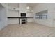 Inviting living room featuring a cozy fireplace, television, and neutral tile flooring at 979 Evening Dew Dr, Las Vegas, NV 89110