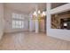 Bright and airy living room with high ceilings, large windows, and tile flooring at 979 Evening Dew Dr, Las Vegas, NV 89110