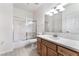 Bright bathroom with wooden cabinets, a shower over the bath and a white countertop and sink at 10100 Jacob Pl # 204, Las Vegas, NV 89144