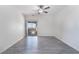 A bedroom with light gray wood-look flooring, access to a balcony, and a ceiling fan at 10100 Jacob Pl # 204, Las Vegas, NV 89144